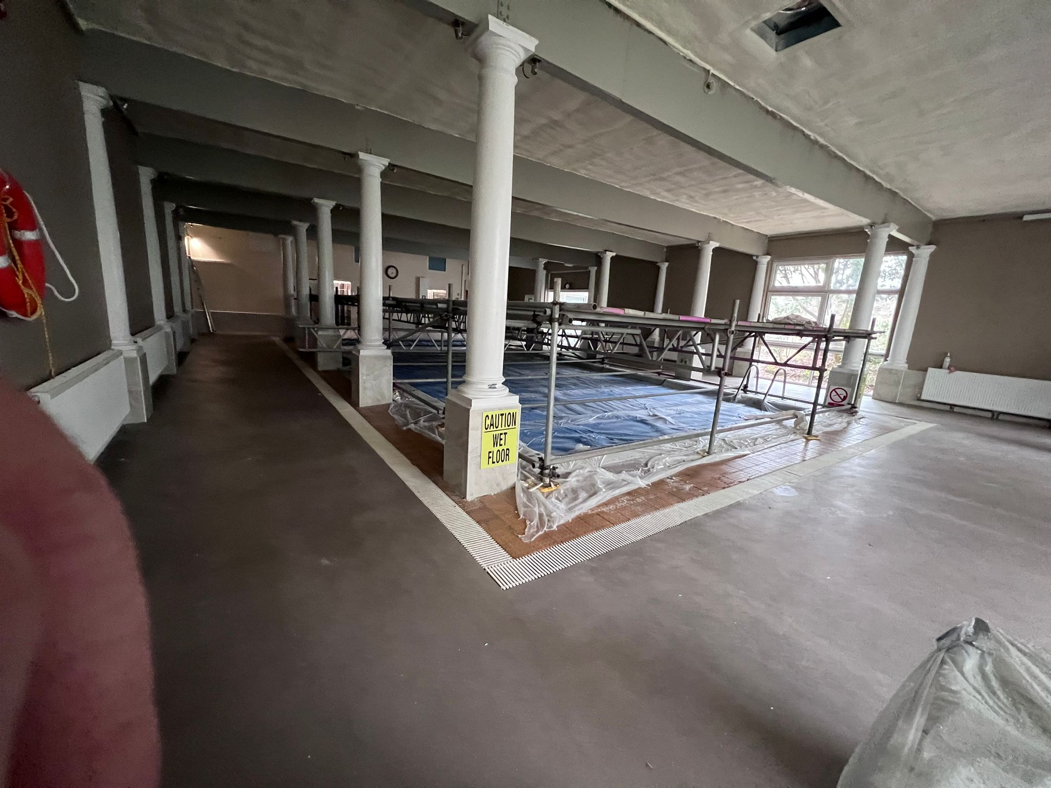 Spray foam between pool hall ceiling beams and columns