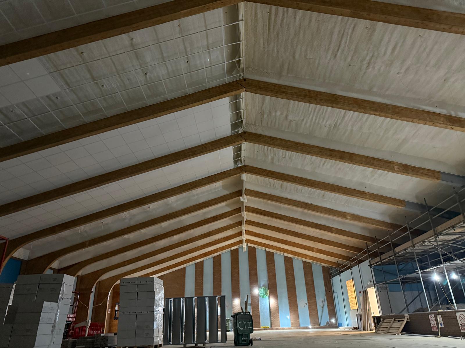 Large public pool spray foam between roof beams
