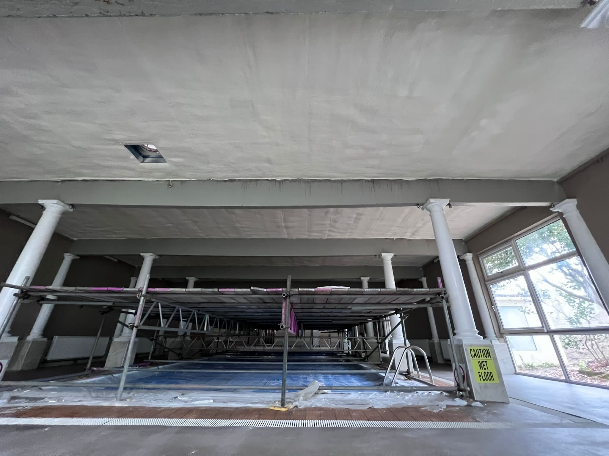 Hotel pool ceiling spray foam insulation close-up